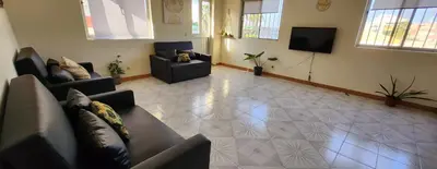a living room with couches and a flat screen tv at MEETING POINT HOSTEL-Praia Group Reservations in Praia