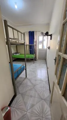 a room with two bunk beds and a door at MEETING POINT HOSTEL-Praia Group Reservations in Praia