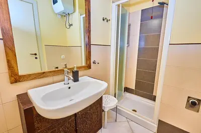 a bathroom with a sink and a shower at Tropical African Vibe in Santa Maria