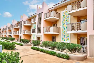 a building with balconies and plants in a courtyard at Tropical African Vibe in Santa Maria