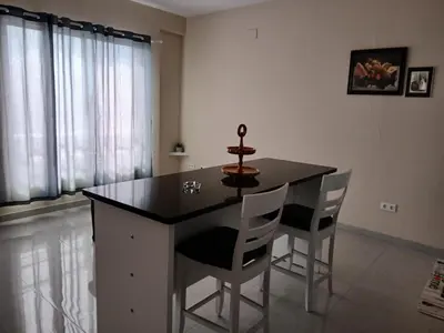 a kitchen with a table and chairs in a room at Cozy Maia in Mindelo