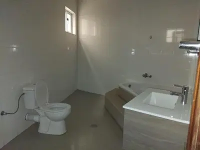 a white bathroom with a toilet and a sink at Assomada Comfort Ap in Assomada
