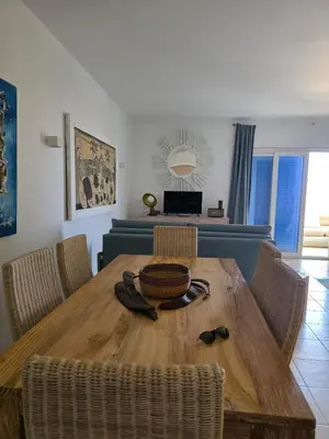 a dining room with a wooden table and chairs at Ricky's - minha kas, tju kaza in Santa Maria