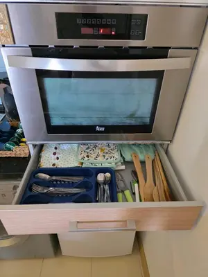a drawer in a refrigerator filled with lots of tools at Ricky's - minha kas, tju kaza in Santa Maria