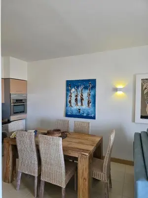 a dining room with a wooden table and chairs at Ricky's - minha kas, tju kaza in Santa Maria