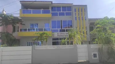 a building with a yellow and blue building at Cafofo in Tarrafal