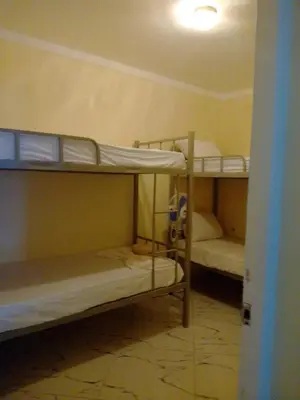 a room with two bunk beds in a room at Please Read Email-Free EARLY Check In & Out-No Walk-Ins or Cash Accepted-Meeting Point Hostels in São Filipe