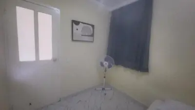 a room with a fan and a window and a door at Please Read Email-Free EARLY Check In & Out-No Walk-Ins or Cash Accepted-Meeting Point Hostels in São Filipe