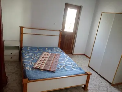 a small bedroom with a bed with a book on it at Bar Residencial Frontera in Mindelo