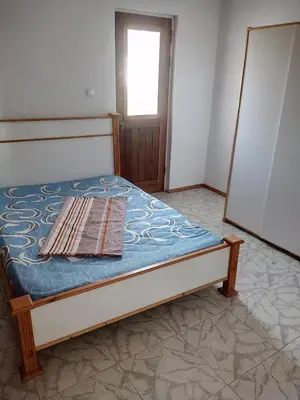 a small bed in a room with a window at Bar Residencial Frontera in Mindelo