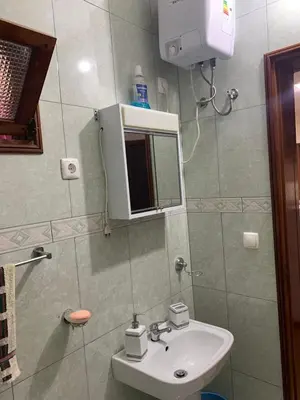 a bathroom with a sink and a mirror at Two Bedroom Condo, Mindelo in Mindelo