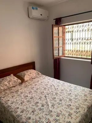 a bedroom with a bed and a window at Two Bedroom Condo, Mindelo in Mindelo