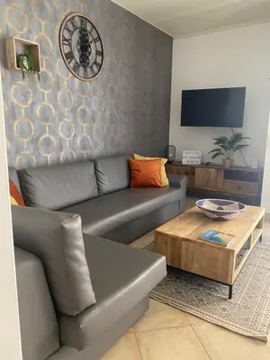 a living room with a couch and a coffee table at Greenland Tropical in Santa Maria