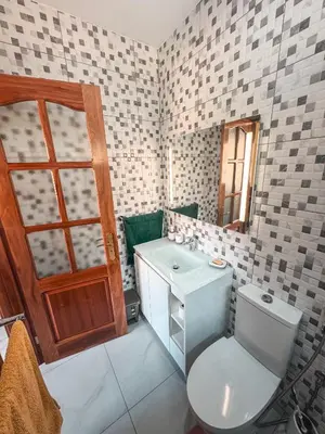a bathroom with a toilet and a sink at Bentub Home pousada in Ribeira Grande