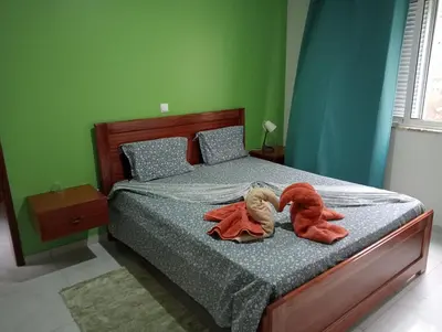 two stuffed animals are sitting on a bed at Bentub Home pousada in Ribeira Grande