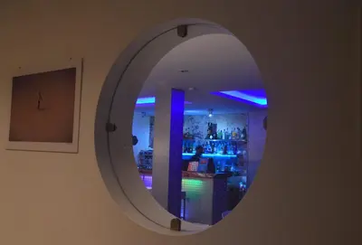 a mirror on a wall in a room with a bar at Prassa 3 Boutique Hotel in Mindelo