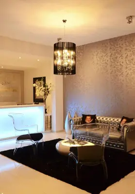 a living room with a couch and a chandelier at Prassa 3 Boutique Hotel in Mindelo