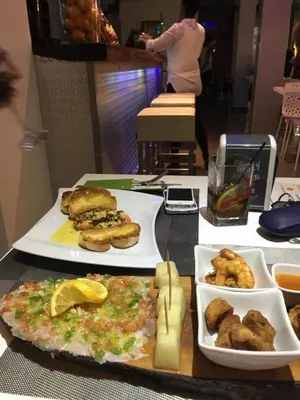 a table with two plates of food on it at Prassa 3 Boutique Hotel in Mindelo