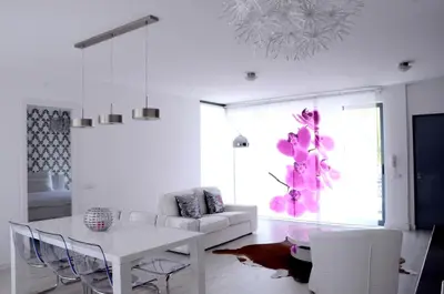 a white living room with a white table and chairs at Prassa 3 Boutique Hotel in Mindelo