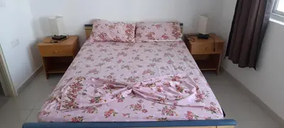 a bedroom with a pink bed with a pink bedspread at Santos Medina in Ribeira Grande