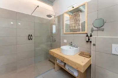 a bathroom with a sink and a mirror and a shower at Barceló Marine Boa Vista - Adults Only in Sal Rei