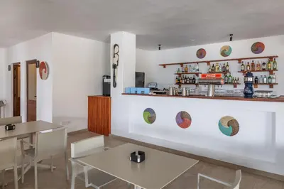 a restaurant with white walls and white tables and chairs at Barceló Marine Boa Vista - Adults Only in Sal Rei