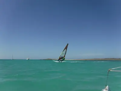 a person windsurfing in the ocean on the water at Vila Cabral 2 Apartments - AC in Sal Rei