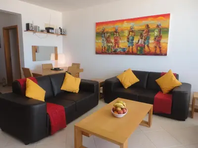 a living room with two couches and a bowl of fruit on a table at Vila Cabral 2 Apartments - AC in Sal Rei