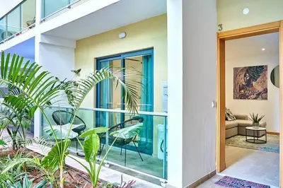 a home with a balcony with chairs and plants at Apartamento Ap3 T1 Santa Maria Residence in Santa Maria