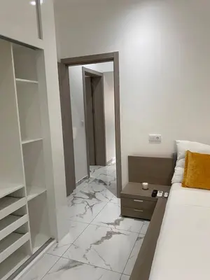 a bedroom with a bed and a mirror and marble floor at Beach House in Calhau
