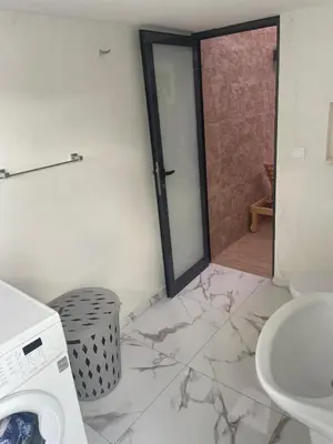 a bathroom with a sink and a washing machine at Beach House in Calhau