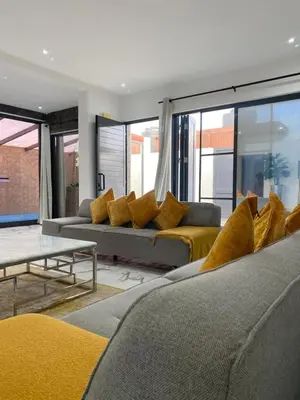 a living room with couches and a table at Beach House in Calhau