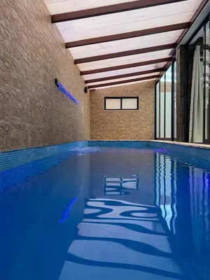 a swimming pool with blue water in a building at Beach House in Calhau