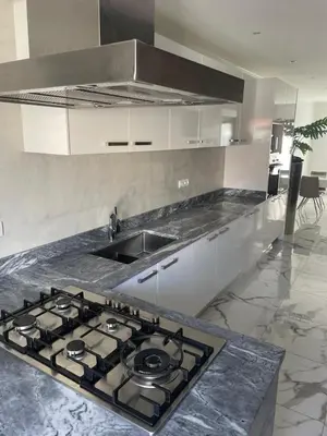 a kitchen with a stove and a counter top at Beach House in Calhau