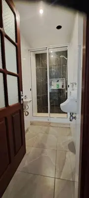 a bathroom with a sink and a window at Studio Cruz Espia in Mindelo