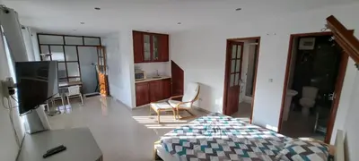 a living room with a bed and a kitchen at Studio Cruz Espia in Mindelo
