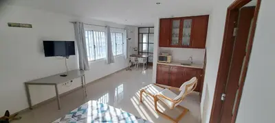 a kitchen with a desk and a table and chairs at Studio Cruz Espia in Mindelo