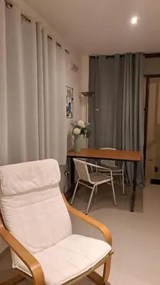 a living room with a chair and a table at Studio Cruz Espia in Mindelo
