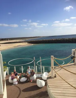 a group of people sitting on the deck of a boat at 2Bed-Vila-Verde Sal Cape Verde-Balcony-Pool in Santa Maria