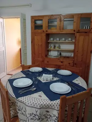 a dining room with a table with plates on it at Holiday Maio in Calheta Do Maio