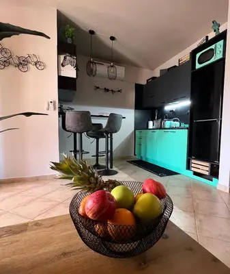 a bowl of fruit on a table in a kitchen at Tropical Manera in Santa Maria