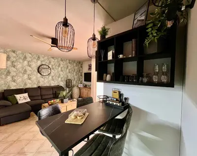 a living room with a table and a couch at Tropical Manera in Santa Maria