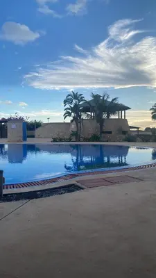 a pool of water with palm trees in the background at Tropical Manera in Santa Maria