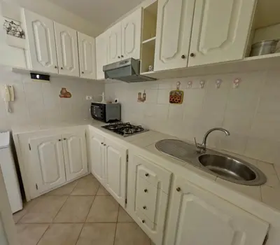 a kitchen with white cabinets and a sink at Ca' Ale in Santa Maria