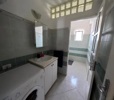 a bathroom with a washing machine and a sink at Ca' Ale in Santa Maria