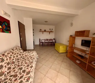 a living room with a couch and a television at Ca' Ale in Santa Maria