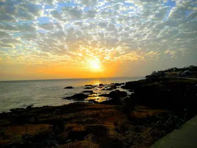 a sunset over the ocean with the sun setting at LT Aparthotel in Praia