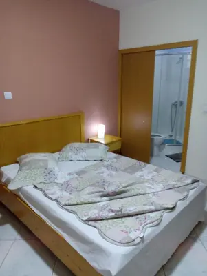a bedroom with a large bed with a candle on it at LT Aparthotel in Praia
