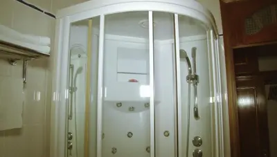 a white cabinet in a bathroom with a shower at Residencial Cosmos in Assomada