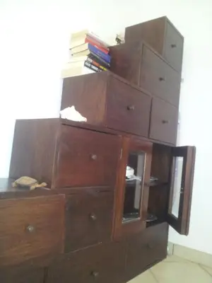 a stack of wooden dressers with books on top at Holiday Properties Commercial Center - Wi-fi in Santa Maria